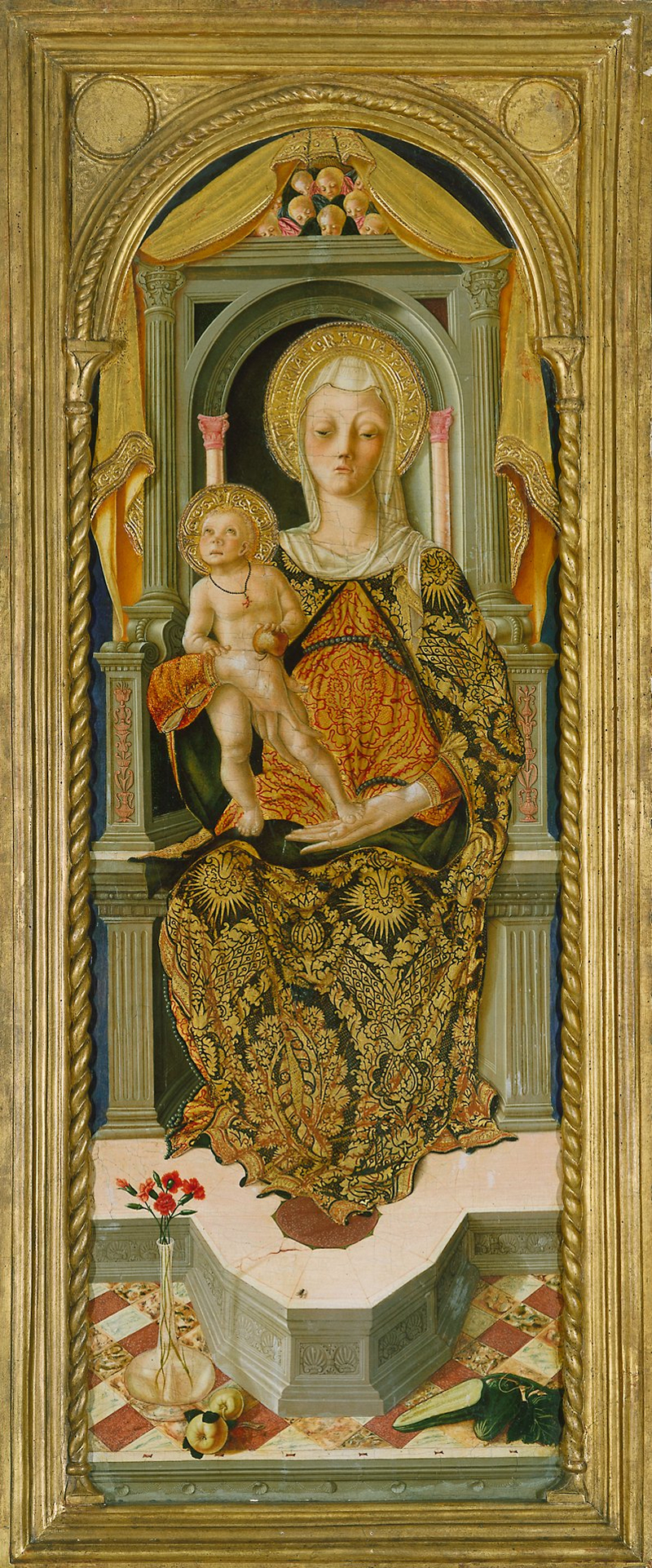 Arched top. The Madonna, in a gold and blue mantle over a red and gold brocade robe, seated on a throne in Renaissance style holding the infant Christ who stands on her knee, an apple in his hand; at the foot of the throne, pinks in a vase, apples, and marrows.